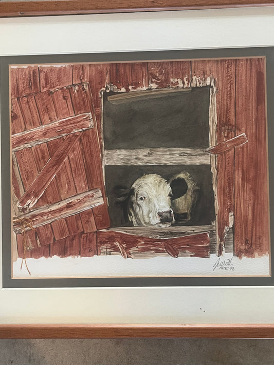 Cows looking over barn door